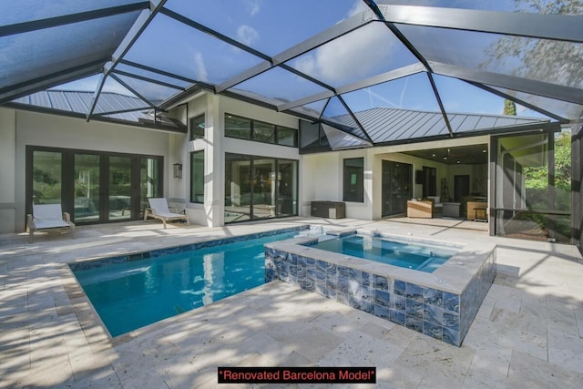 view of pool featuring an in ground hot tub, glass enclosure, and a patio area