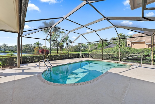 view of pool featuring a patio area, a water view, and glass enclosure