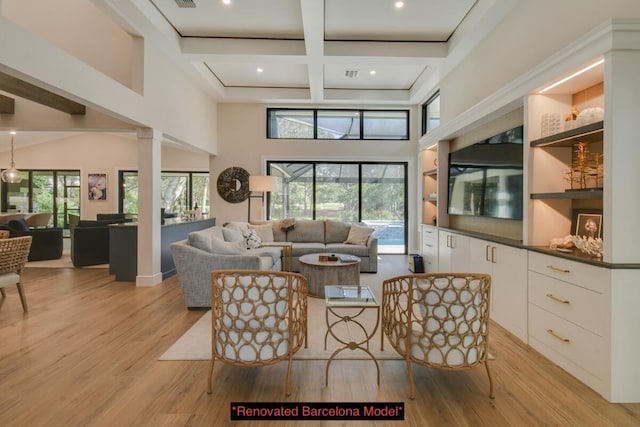 living room featuring coffered ceiling, light hardwood / wood-style flooring, plenty of natural light, and beam ceiling