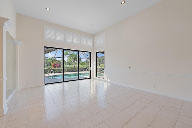 tiled empty room with a high ceiling