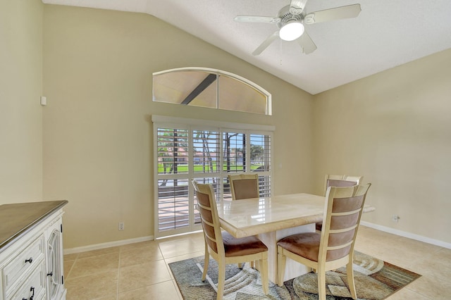 dining space featuring lofted ceiling, ceiling fan, and light tile patterned floors