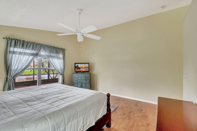 bedroom with light wood-type flooring, vaulted ceiling, and ceiling fan