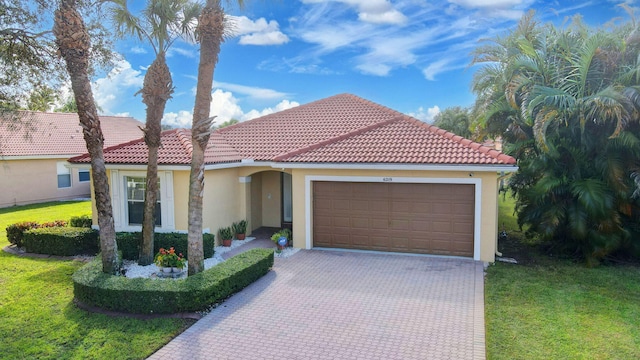 mediterranean / spanish house featuring a garage and a front lawn