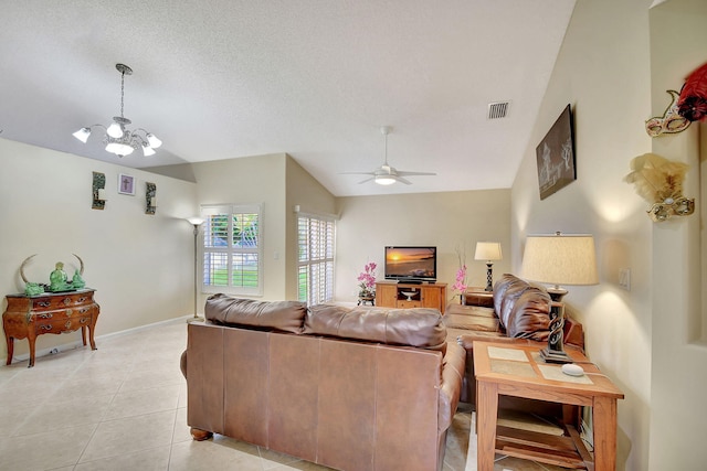 tiled living room with a textured ceiling, ceiling fan with notable chandelier, and vaulted ceiling