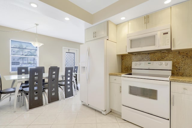 kitchen featuring backsplash, white appliances, light tile patterned floors, decorative light fixtures, and cream cabinetry