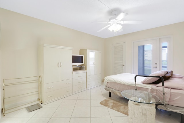 bedroom with ceiling fan, light tile patterned floors, and access to outside