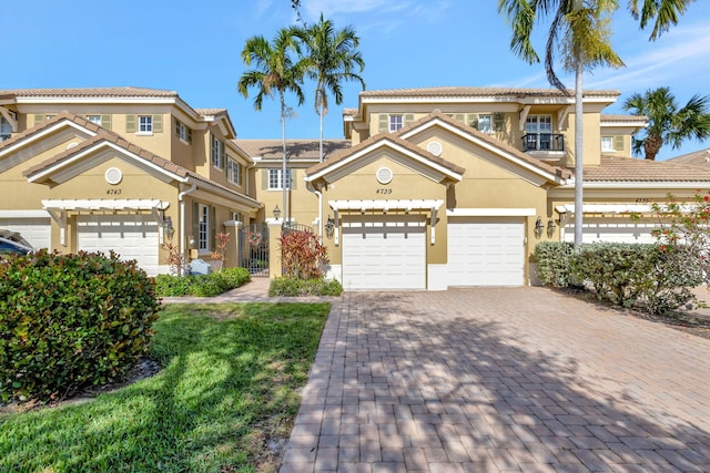 mediterranean / spanish-style house with a garage