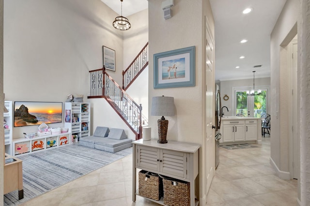 interior space with a chandelier and crown molding