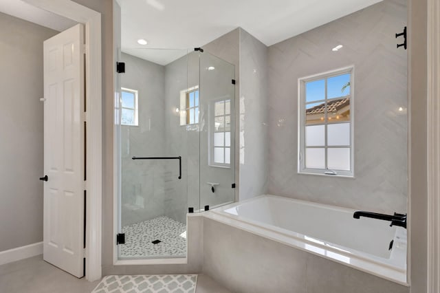 bathroom featuring tile patterned flooring and independent shower and bath