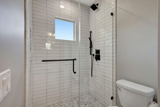 bathroom featuring an enclosed shower and toilet