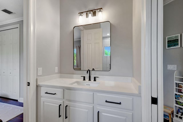 bathroom featuring vanity and ornamental molding