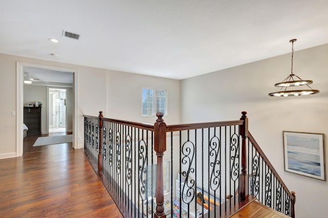 hallway featuring dark hardwood / wood-style floors and a notable chandelier