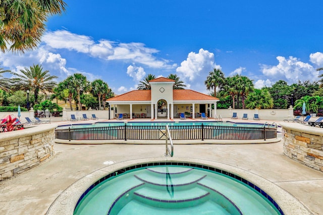 view of swimming pool with a community hot tub and a patio