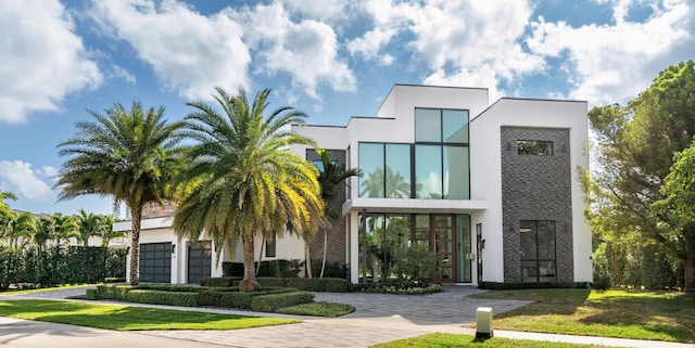 view of front of house featuring a front lawn and french doors