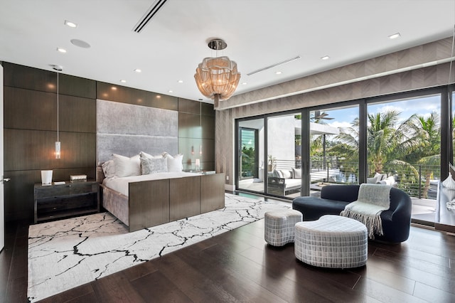 bedroom with access to exterior, dark hardwood / wood-style flooring, and a notable chandelier