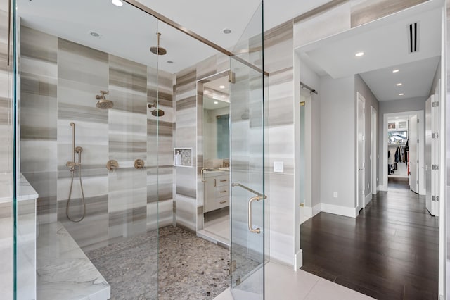 bathroom featuring vanity and an enclosed shower