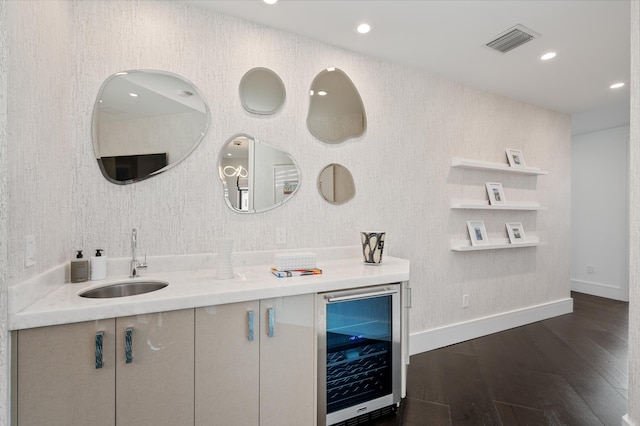 bathroom featuring hardwood / wood-style floors, sink, and beverage cooler