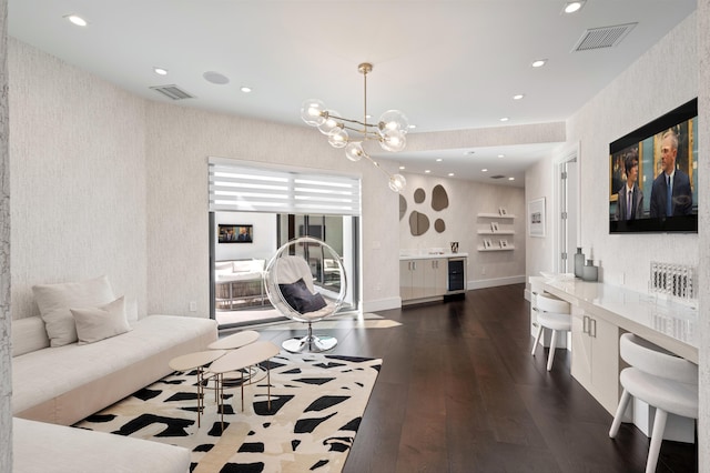 living room with wine cooler, dark hardwood / wood-style flooring, and a chandelier