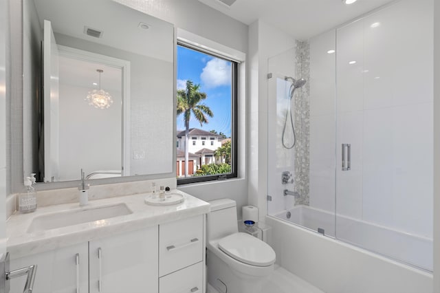 full bathroom with vanity, toilet, and shower / bath combination with glass door