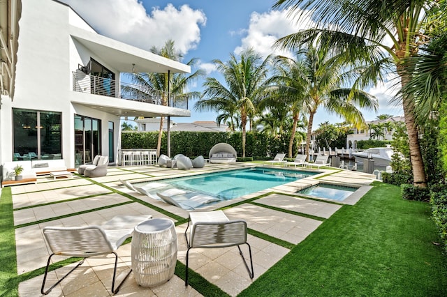 view of swimming pool featuring an in ground hot tub and a patio