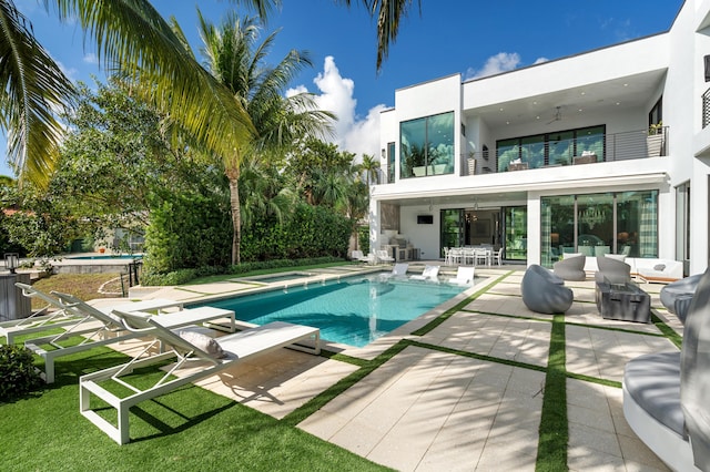 view of pool with a jacuzzi and a patio