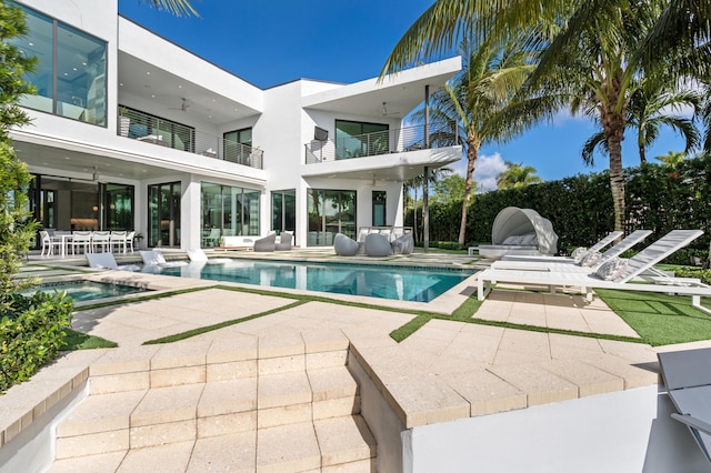 view of pool with a patio area and an in ground hot tub