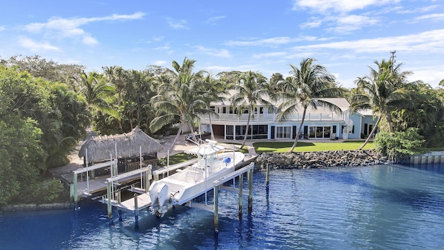 view of dock with a yard and a water view