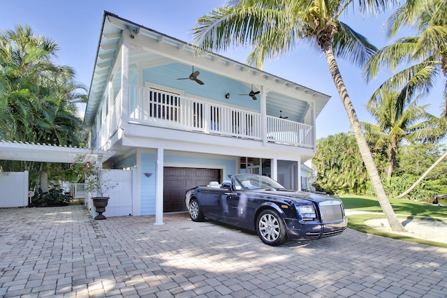 beach home featuring a garage and ceiling fan