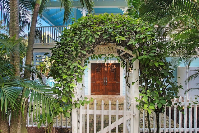 view of exterior entry featuring a balcony