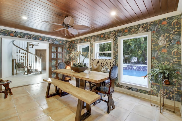 dining space featuring ceiling fan, ornamental molding, and wood ceiling