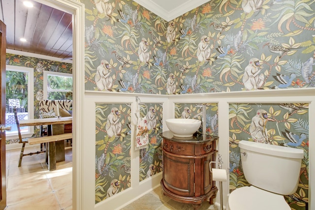 bathroom with toilet, ornamental molding, and vanity