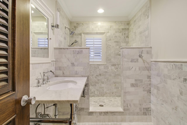 bathroom with sink, tile walls, tiled shower, and ornamental molding