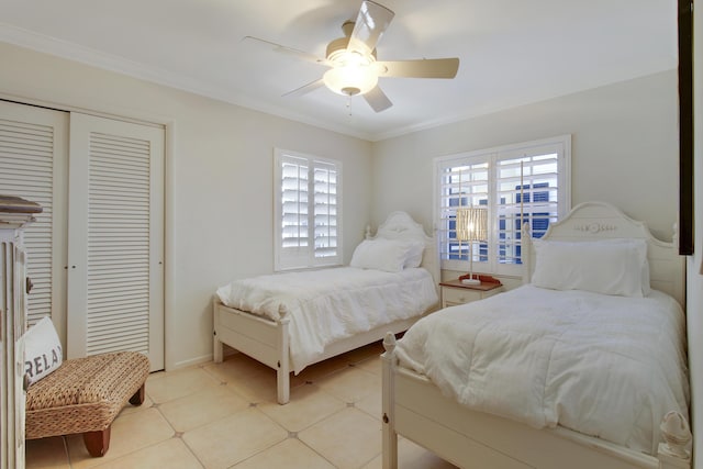 tiled bedroom with ceiling fan, ornamental molding, and a closet