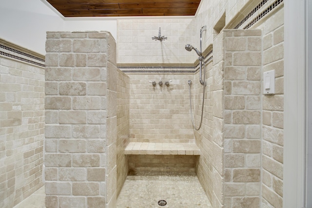 bathroom featuring wood ceiling and a tile shower