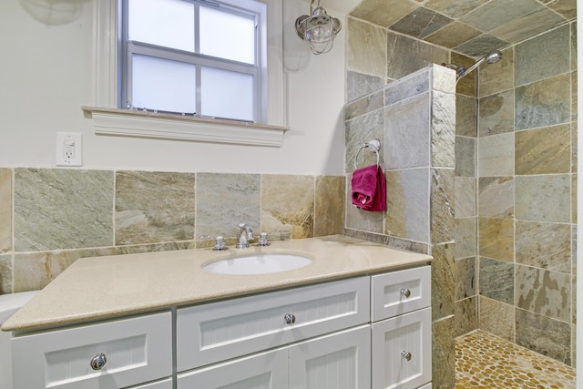 bathroom with vanity and a tile shower