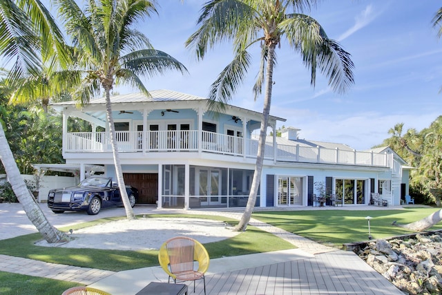 back of property featuring ceiling fan and a balcony