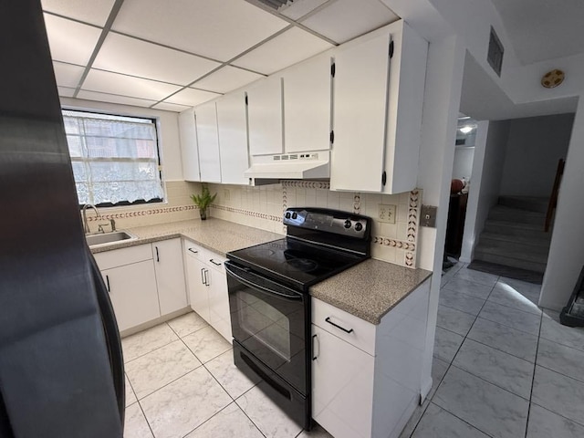 kitchen with backsplash, black electric range oven, a sink, and under cabinet range hood