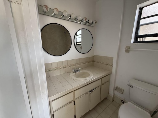 bathroom featuring tile patterned flooring, vanity, and toilet