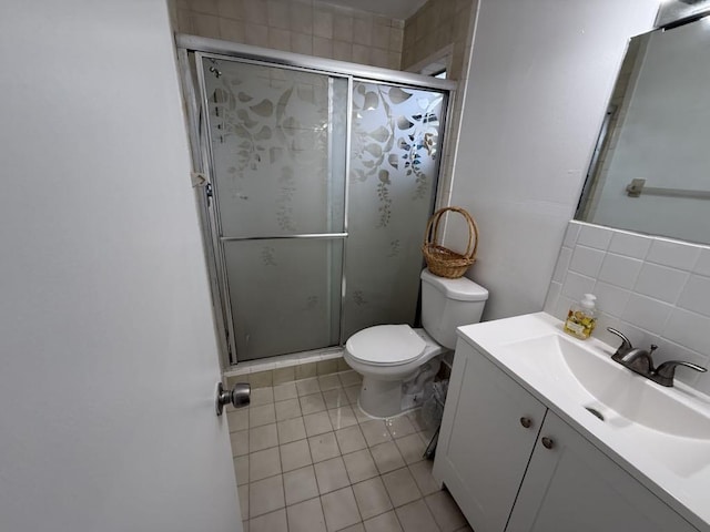 full bathroom with toilet, tile patterned floors, vanity, a shower stall, and backsplash