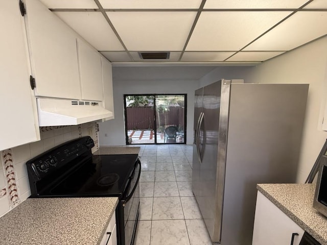 kitchen featuring black range with electric cooktop, under cabinet range hood, white cabinetry, visible vents, and freestanding refrigerator