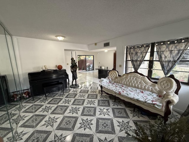 living room with visible vents and a textured ceiling