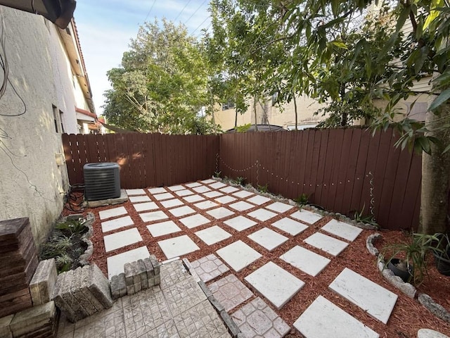 view of patio / terrace with a fenced backyard and central air condition unit