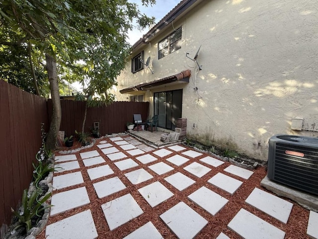 view of patio featuring a fenced backyard and central air condition unit