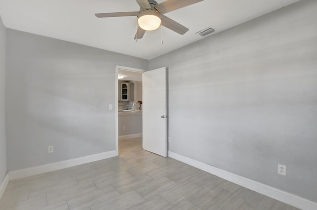 unfurnished room with ceiling fan