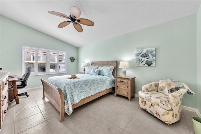 bedroom with light tile patterned floors, vaulted ceiling, and ceiling fan