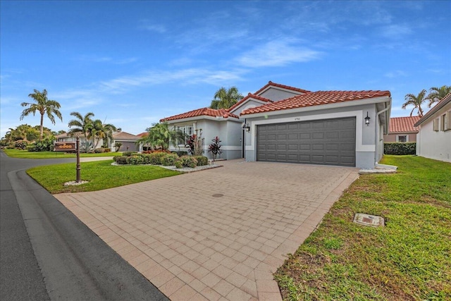 mediterranean / spanish home with a front lawn and a garage