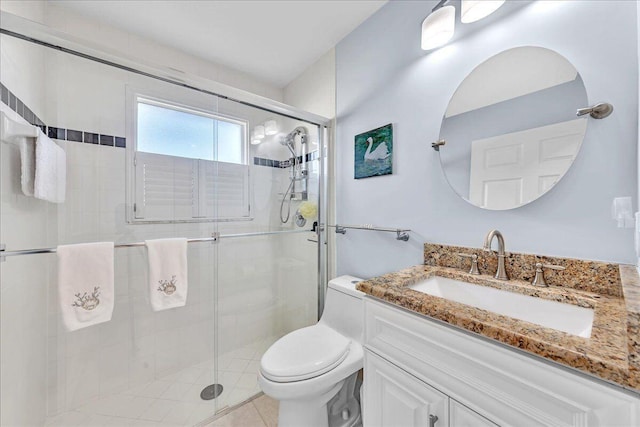 bathroom with toilet, vanity, tile patterned floors, and a shower with door