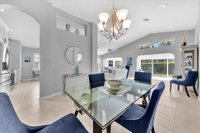 dining area featuring light tile patterned floors, ceiling fan with notable chandelier, and a healthy amount of sunlight