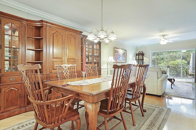 dining space featuring ceiling fan with notable chandelier, light hardwood / wood-style floors, and ornamental molding