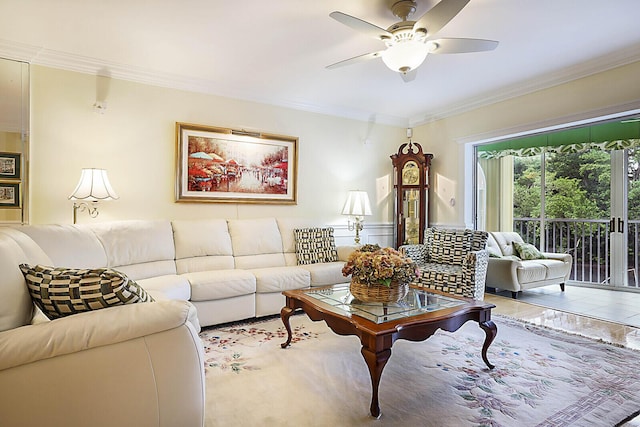 tiled living room with ceiling fan and crown molding